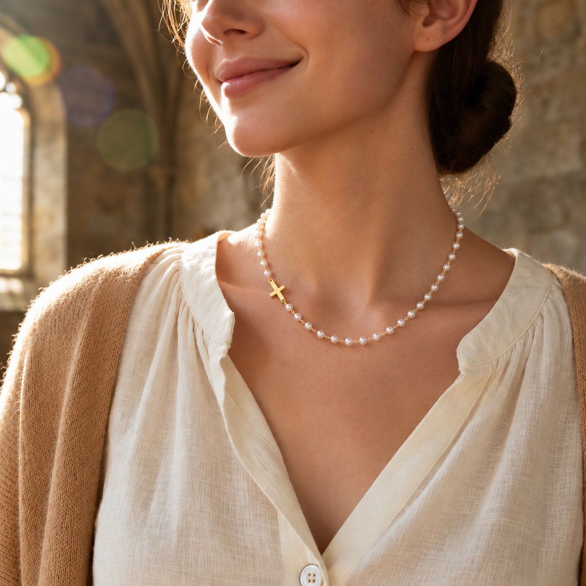 Woman wearing the Grace Cross Necklace in soft sunlight